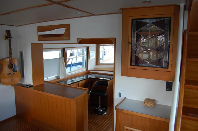 Slide: The Image of Interior of 1982 Miller Marine North Sea Trawler with wood finishes and guitar on wall. - 41