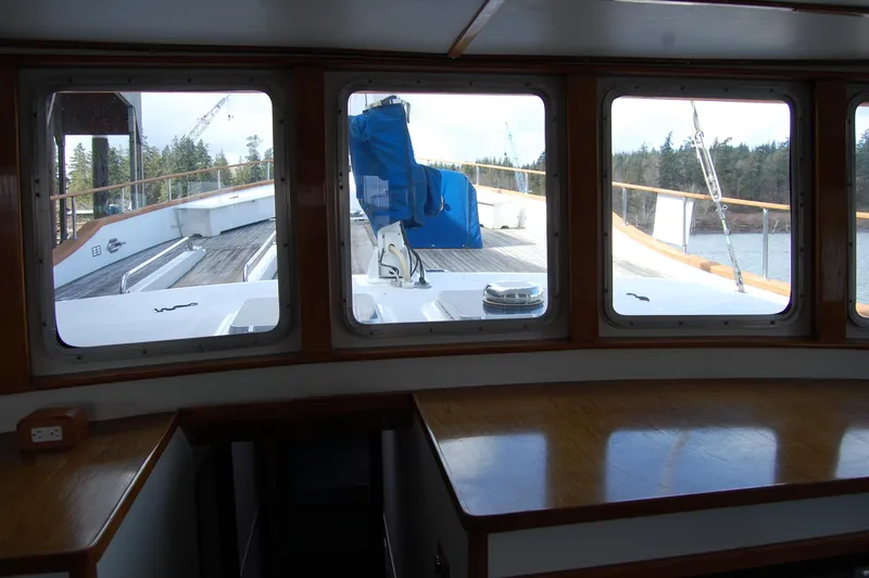 Slide: The Image of 1982 Miller Marine North Sea Trawler interior view through windows, showcasing deck and outdoor scenery. - 44