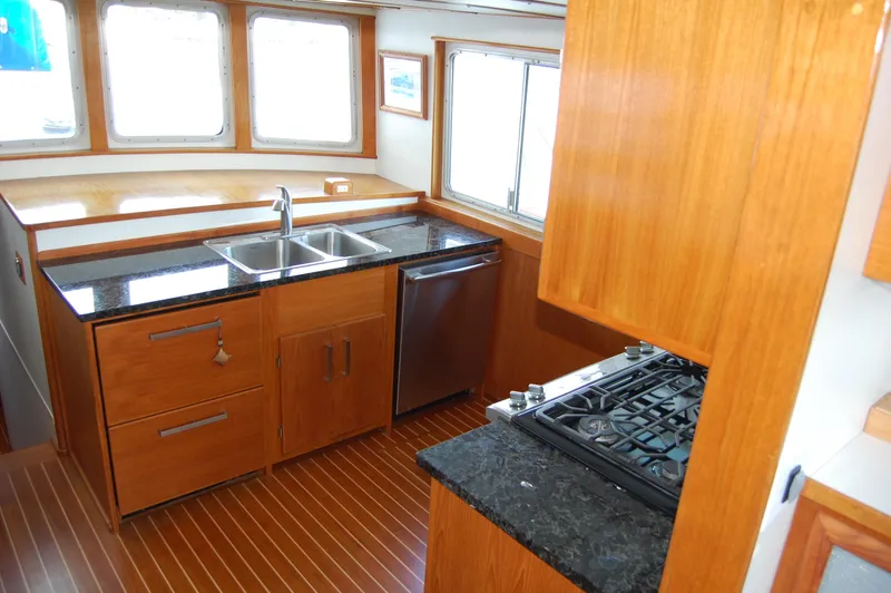 Slide: The Image of Interior of 1982 Miller Marine North Sea Trawler, featuring a modern kitchen with wood cabinetry. - 45