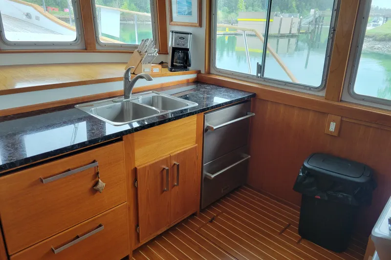 Slide: The Image of Kitchen area of 1982 Miller Marine North Sea Trawler with wood cabinetry and dual sink. - 46