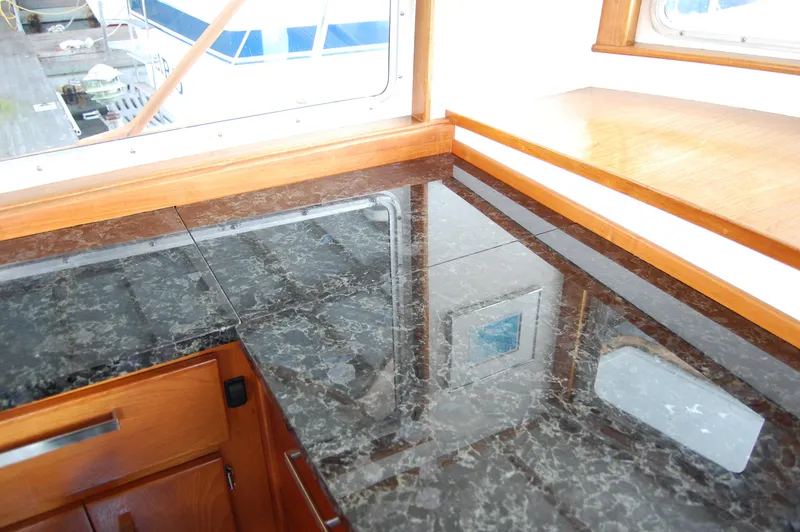 Slide: The Image of Interior of 1982 Miller Marine North Sea Trawler with marble countertop and wooden cabinetry. - 47