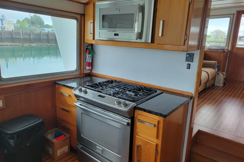 Slide: The Image of Kitchen area of 1982 Miller Marine North Sea Trawler with stove and microwave. - 49