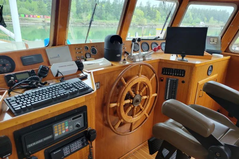 Slide: The Image of Bridge of 1982 Miller Marine North Sea Trawler, featuring navigation equipment and wooden helm. - 84
