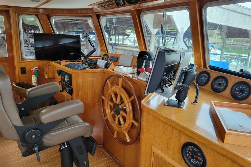 Slide: The Image of Interior of 1982 Miller Marine North Sea Trawler, featuring helm and navigation equipment. - 86