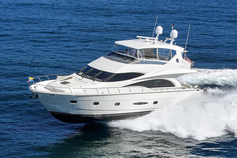 Slide: The Image of 2005 Marquis 65 yacht cruising on open sea, showcasing sleek design and luxury. - 10