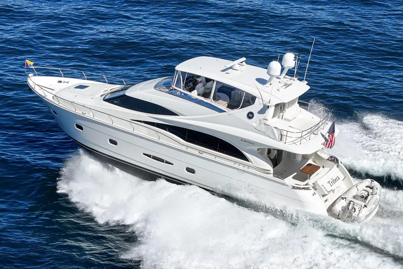 Slide: The Image of Luxurious 2005 Marquis 65 yacht cruising on open blue waters. - 15