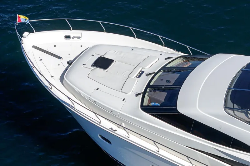 Slide: The Image of Luxury 2005 Marquis 65 yacht on open water, sleek design and spacious deck. - 17