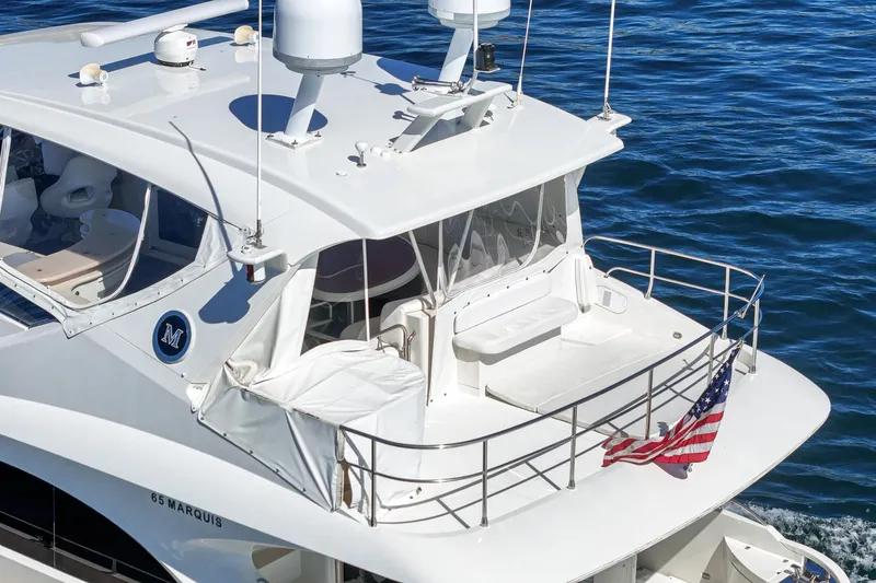 Slide: The Image of Luxury 2005 Marquis 65 yacht cruising on blue ocean waters. - 20