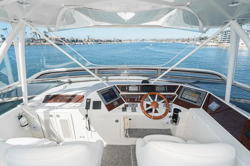 Slide: The Image of Helm of 2005 Marquis 65 yacht with modern navigation equipment and ocean view. - 22