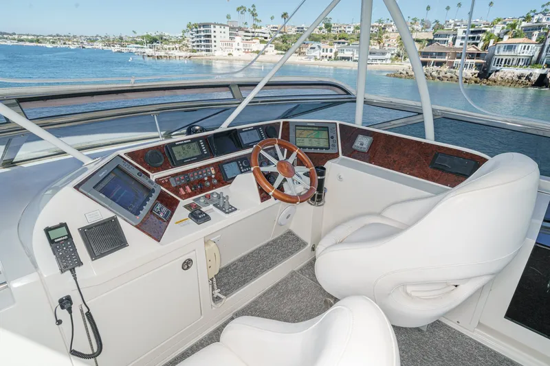 Slide: The Image of Helm of 2005 Marquis 65 yacht with modern navigation equipment and luxurious seating. - 23