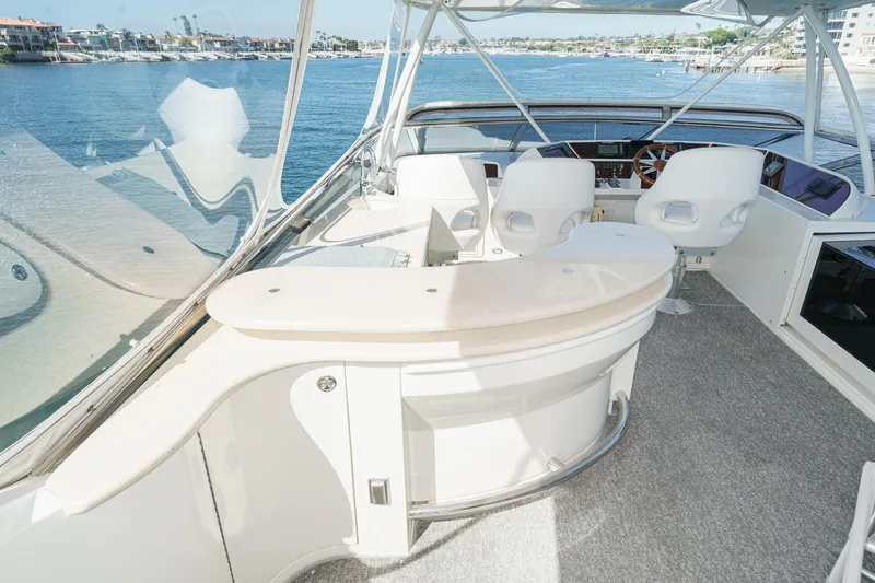 Slide: The Image of Luxurious 2005 Marquis 65 yacht interior with helm, overlooking serene waterfront views. - 24