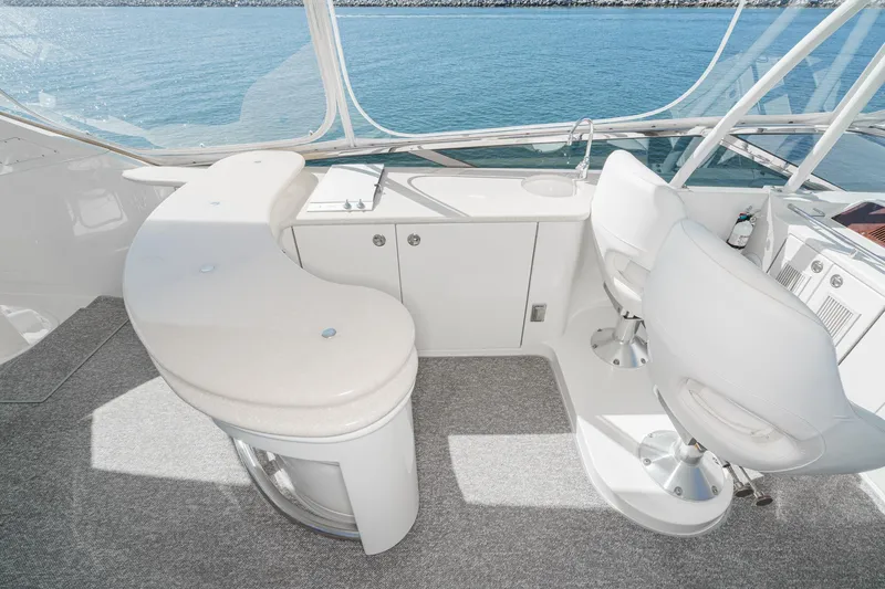 Slide: The Image of Luxurious 2005 Marquis 65 yacht interior with bar and seating, overlooking serene water. - 25
