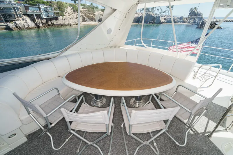 Slide: The Image of Luxurious 2005 Marquis 65 yacht interior with round table, white seating, and ocean view. - 29