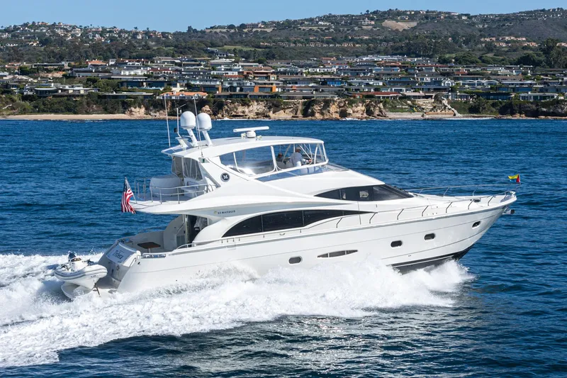 Slide: The Image of Luxurious 2005 Marquis 65 yacht cruising near scenic coastline. - 3