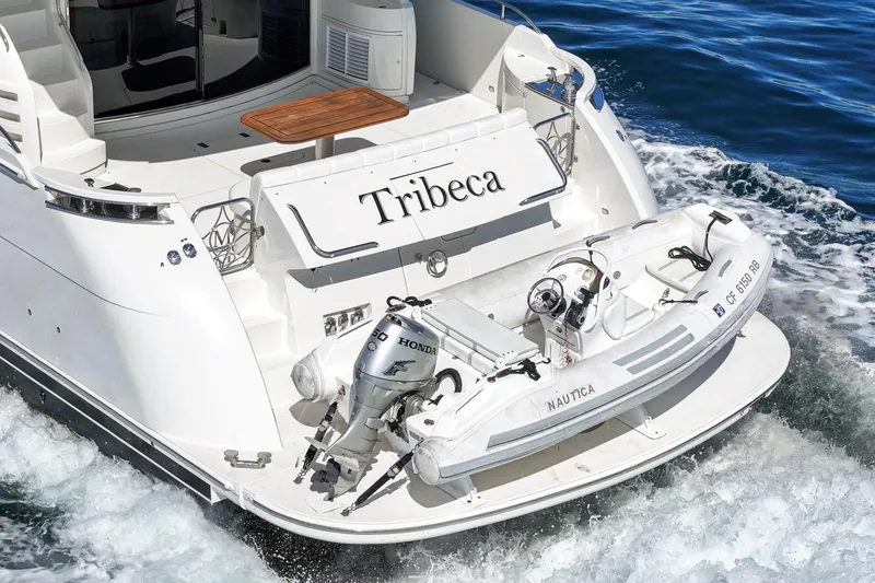 Slide: The Image of Luxury 2005 Marquis 65 yacht with tender boat on the water. - 30