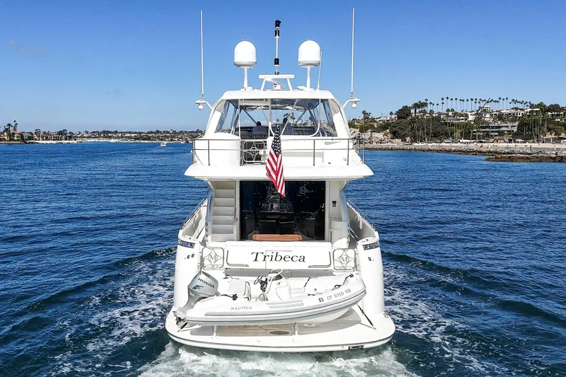 Slide: The Image of Luxury 2005 Marquis 65 yacht cruising on blue waters near scenic coastline. - 34