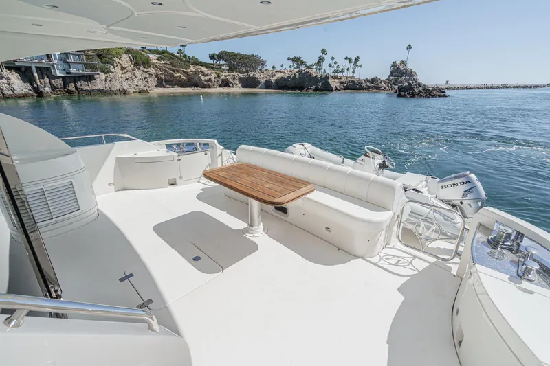 Slide: The Image of Luxury Marquis 65 yacht deck with seating, table, and scenic ocean view, 2005 model. - 40