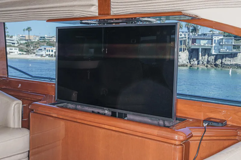 Slide: The Image of Flat-screen TV on 2005 Marquis 65 yacht with scenic waterfront view. - 48