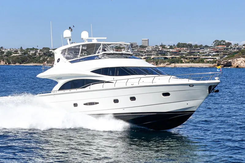 Slide: The Image of Luxury 2005 Marquis 65 yacht cruising on blue ocean near coastal cityscape. - 5