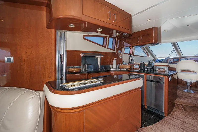 Slide: The Image of Luxurious 2005 Marquis 65 yacht interior with modern kitchen and elegant wood finishes. - 51