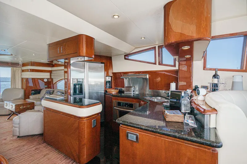 Slide: The Image of Luxurious interior of a 2005 Marquis 65 yacht with modern kitchen and seating area. - 52