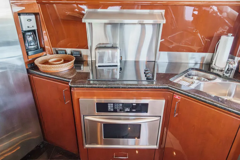 Slide: The Image of Luxurious 2005 Marquis 65 yacht kitchen with modern appliances and sleek wood cabinetry. - 53