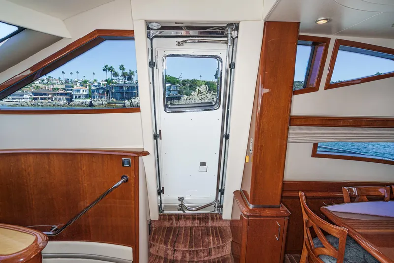 Slide: The Image of Interior of 2005 Marquis 65 yacht with elegant wood finish and scenic windows. - 57