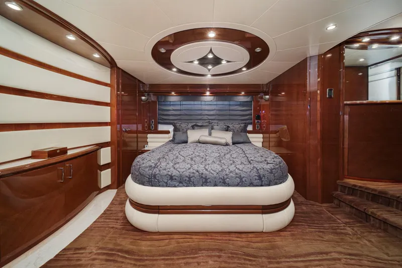 Slide: The Image of Luxurious 2005 Marquis 65 yacht bedroom with elegant wood paneling and plush bedding. - 60