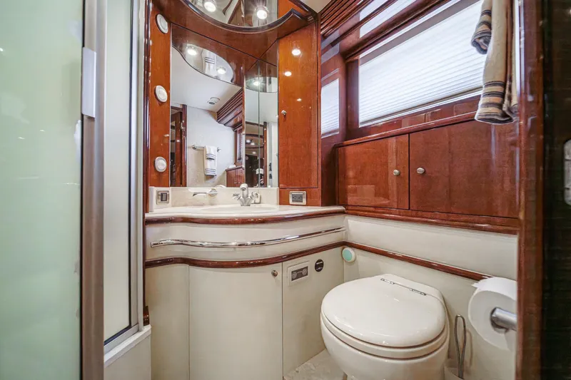 Slide: The Image of Luxurious bathroom in 2005 Marquis 65 yacht with wood accents and modern fixtures. - 68