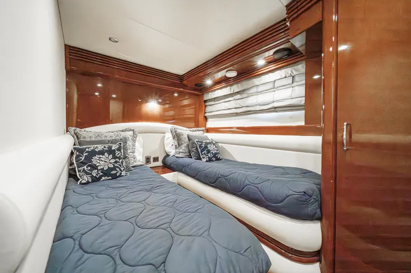Slide: The Image of Luxurious 2005 Marquis 65 yacht cabin with twin beds and elegant wood finish. - 72