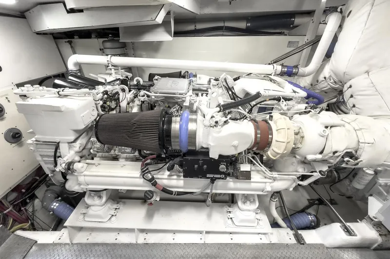 Slide: The Image of Engine room of a 2005 Marquis 65 yacht, showcasing a powerful marine engine. - 80