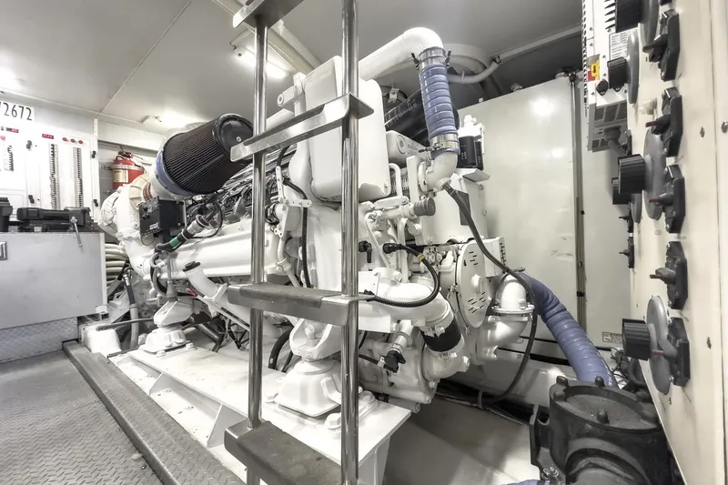 Slide: The Image of Engine room of a 2005 Marquis 65 yacht, showcasing machinery and control panels. - 81