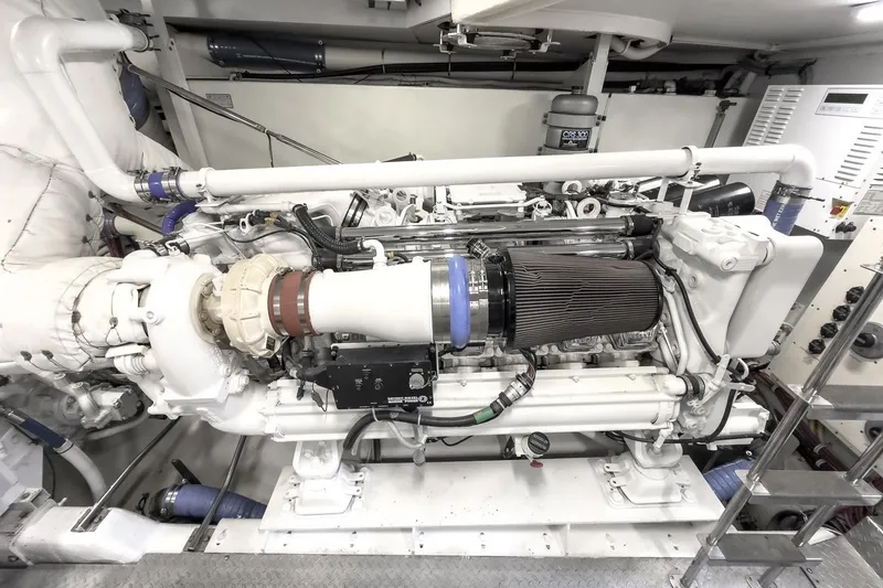 Slide: The Image of Engine room of a 2005 Marquis 65 yacht, showcasing a powerful marine engine. - 82