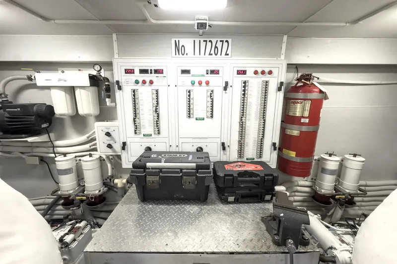 Slide: The Image of Engine room of 2005 Marquis 65 yacht with control panels and safety equipment. - 84