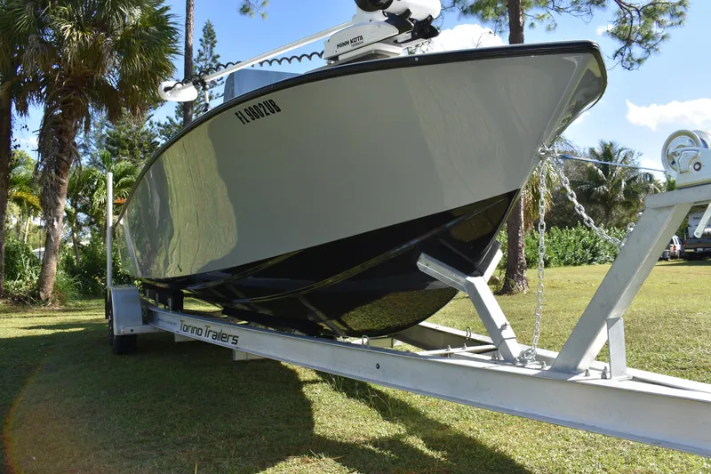 Slide: The Image of 2025 Latitude Tournament Boats 25 with powerful outboard motor, parked on a trailer. - 11