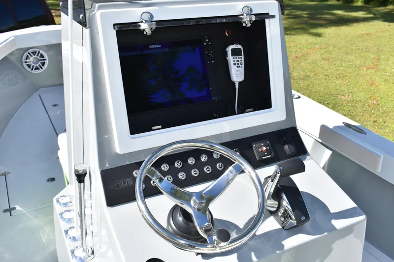 Slide: The Image of 2025 Latitude Tournament Boats 25 on trailer, surrounded by lush greenery. - 14