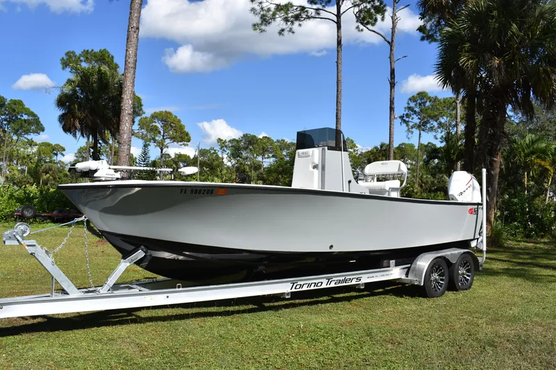 Slide: The Image of 2025 Latitude Tournament Boats 25 cruising on open water, showcasing sleek design and performance. - 2