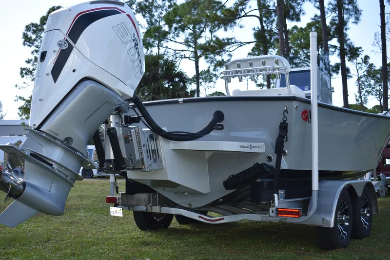 Slide: The Image of 2025 Latitude Tournament Boats 25 on trailer, parked in a scenic outdoor setting. - 8