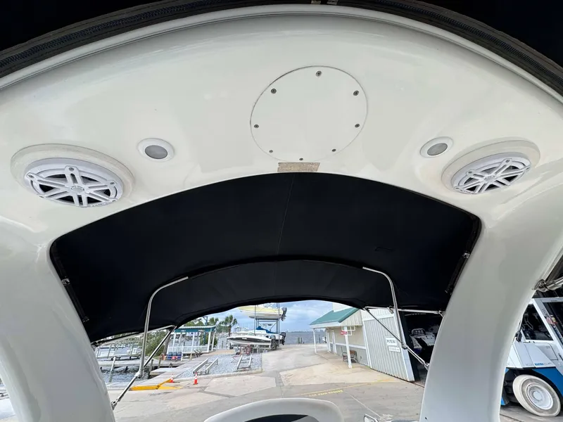Slide: The Image of 2007 Chaparral SSX 276 boat interior with speakers and canopy at a marina. - 20