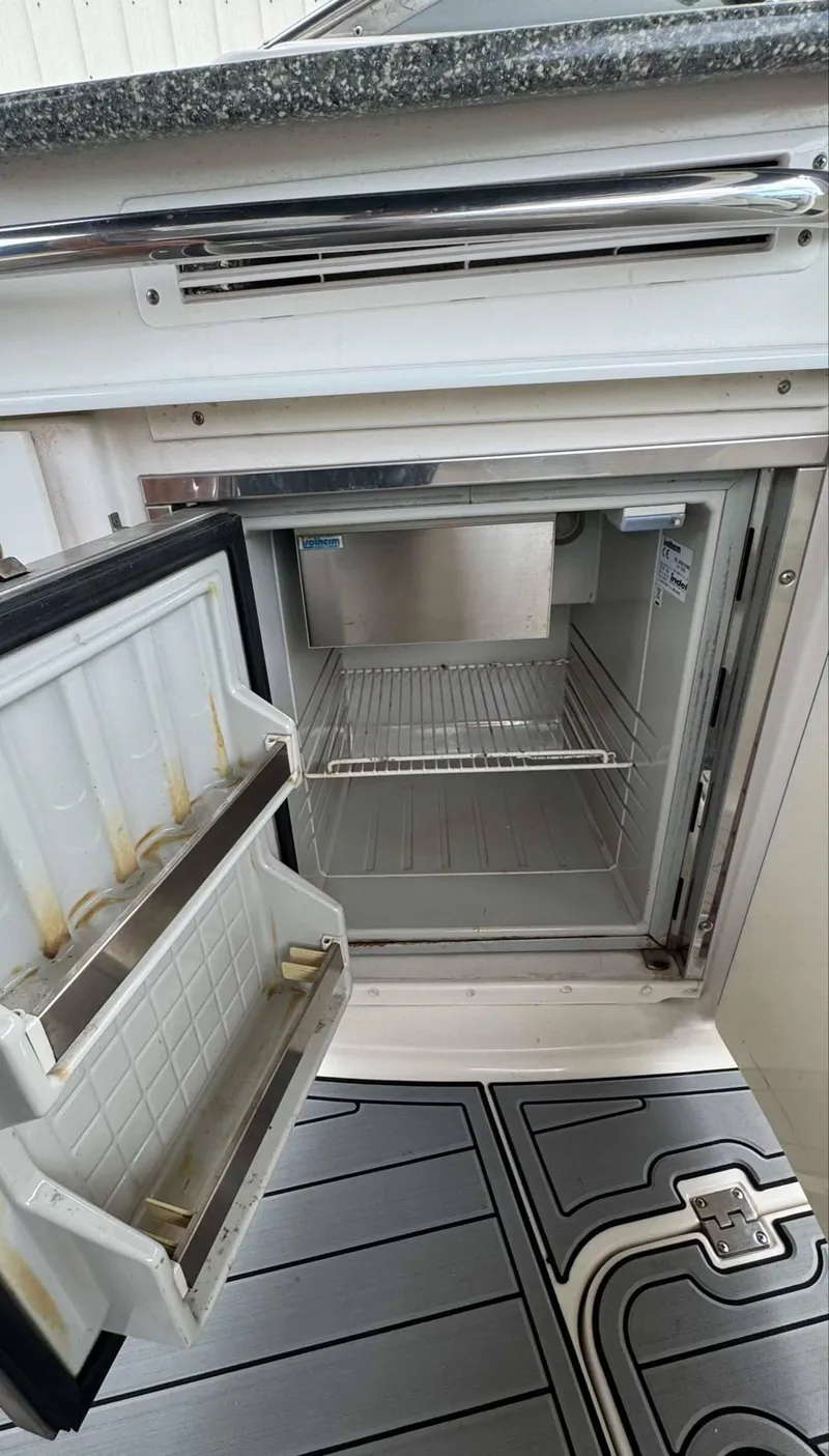 Slide: The Image of 2007 Chaparral SSX 276 boat refrigerator with open door and shelving. - 27