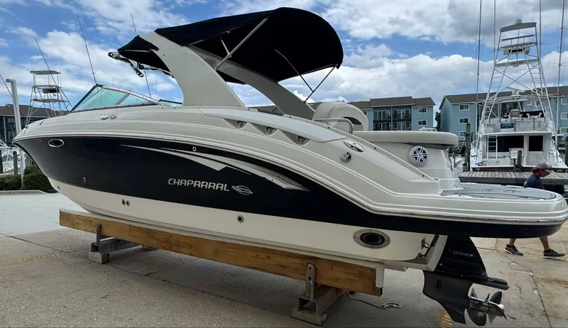 Slide: The Image of 2007 Chaparral SSX 276 boat on display at a marina, featuring sleek design and black hull. - 6
