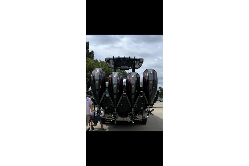 Slide: The Image of 2024 Fountain 38 SC boat with four powerful outboard engines, rear view. - 1