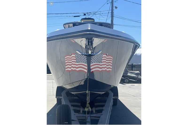 Slide: The Image of 2024 Fountain 38 SC boat with American flag decals on trailer. - 2