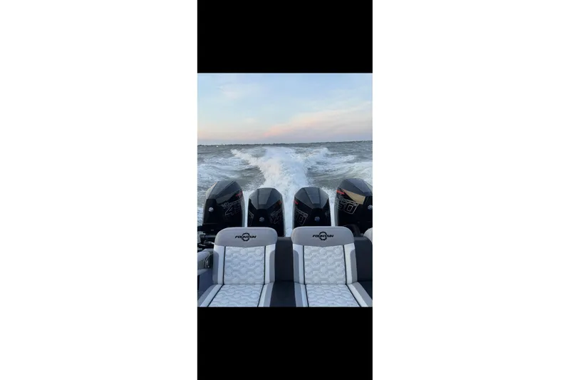 Slide: The Image of 2024 Fountain 38 SC boat with powerful engines cruising on open water. - 3