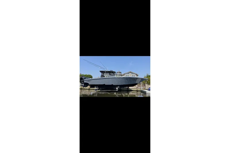 Slide: The Image of 2024 Fountain 38 SC boat docked, sleek design, clear sky background. - 4