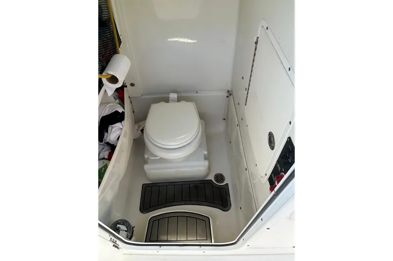 Slide: The Image of 2019 Sea Hunt Gamefish 27 boat interior with toilet and storage area. - 10