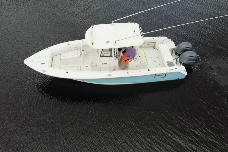 Slide: The Image of 2019 Sea Hunt Gamefish 27 boat on water, aerial view, with dual engines. - 15