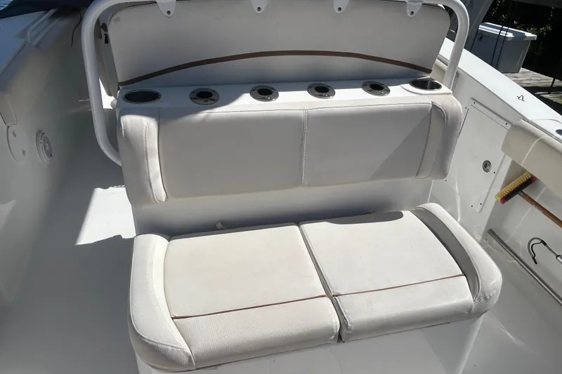 Slide: The Image of 2019 Sea Hunt Gamefish 27 boat seating with cup holders, white upholstery. - 8