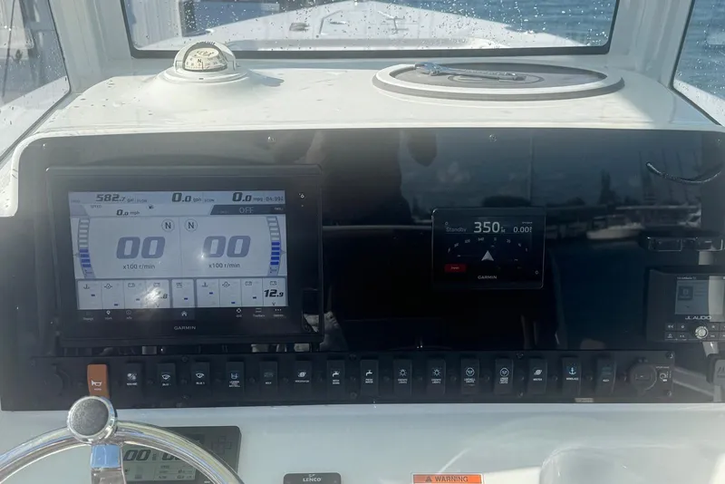 Slide: The Image of Dashboard of a 2019 Sea Hunt Ultra 275 SE boat with Garmin displays. - 16