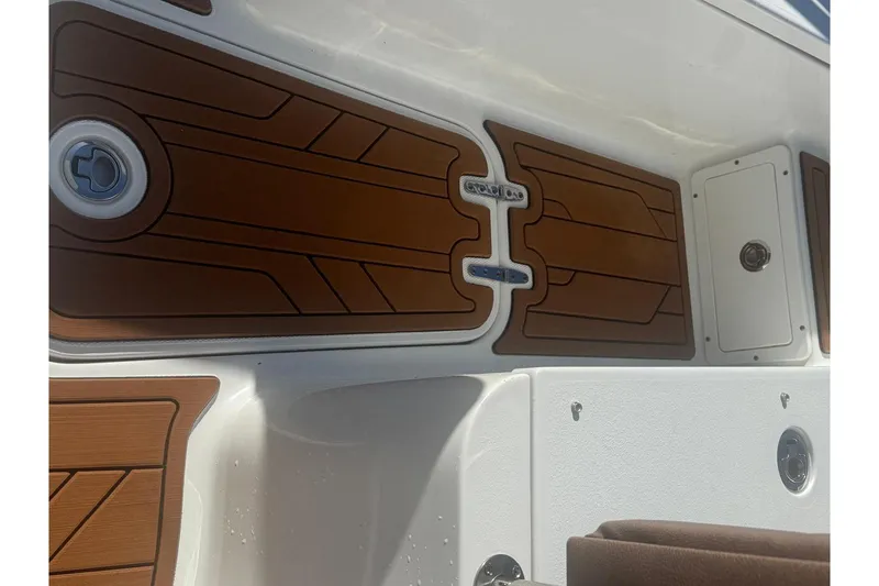 Slide: The Image of 2019 Sea Hunt Ultra 275 SE boat interior with brown and white detailing. - 17